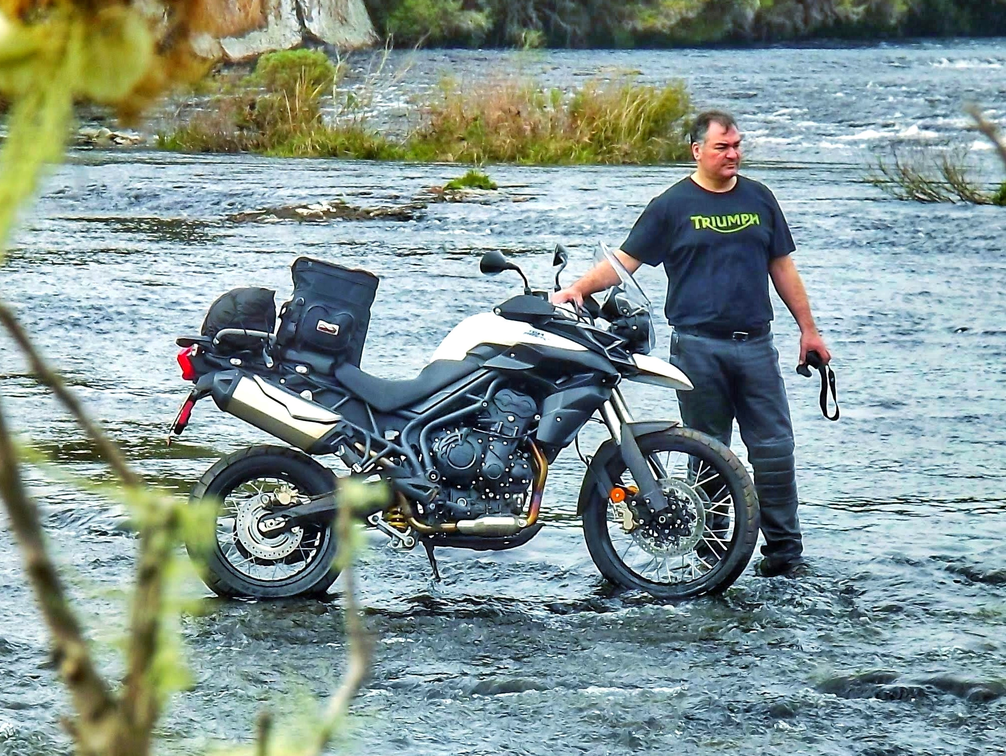 Jerre Rocha com moto em meio à natureza